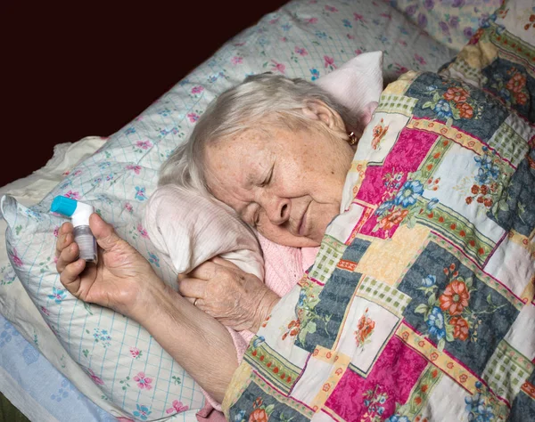 Old sick woman with asthma inhaler — Stock Photo, Image