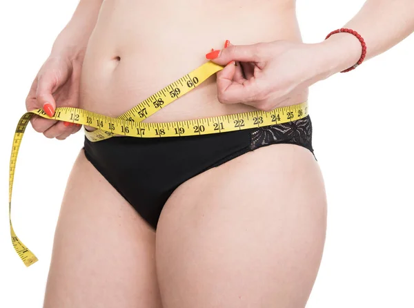 Overweight woman measuring waistline — Stock Photo, Image