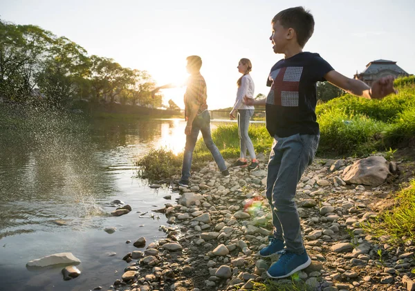 Happy children playing near the river. — Stock Photo, Image