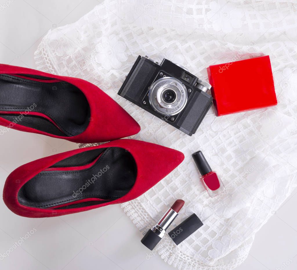 Female elegant outfit shoes, cosmetics and camera