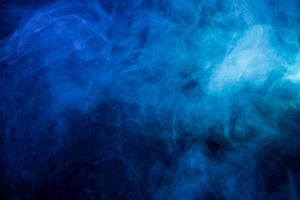 Abstract blue smoke on a dark background. Blue smoke background