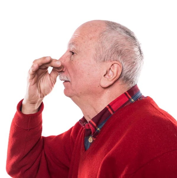 Senior man holding her nose because of a bad smell isolated on w — Stock Photo, Image