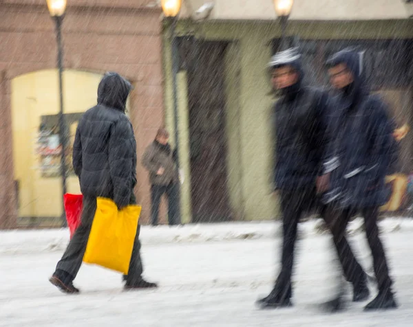 Busy city people going along the street in winter snowy day Stock Photo