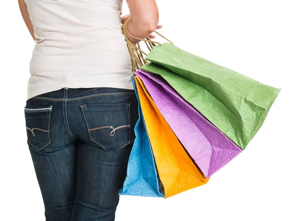 Mulher posando com sacos de compras em um fundo branco — Fotografia de Stock