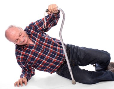  Senior man fell to the floor and cannot stand up over the white