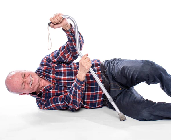 Senior man fell to the floor and cannot stand up over the white Stock Image