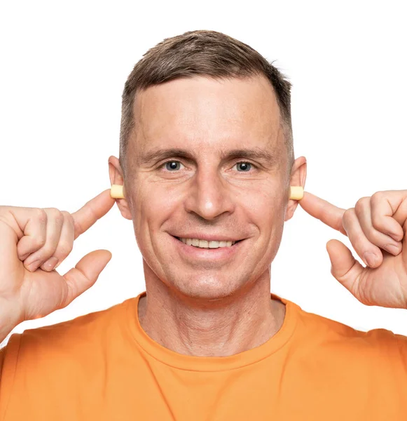 Young Caucasian Man Inserting Earplugs His Ears White Background Royalty Free Stock Images