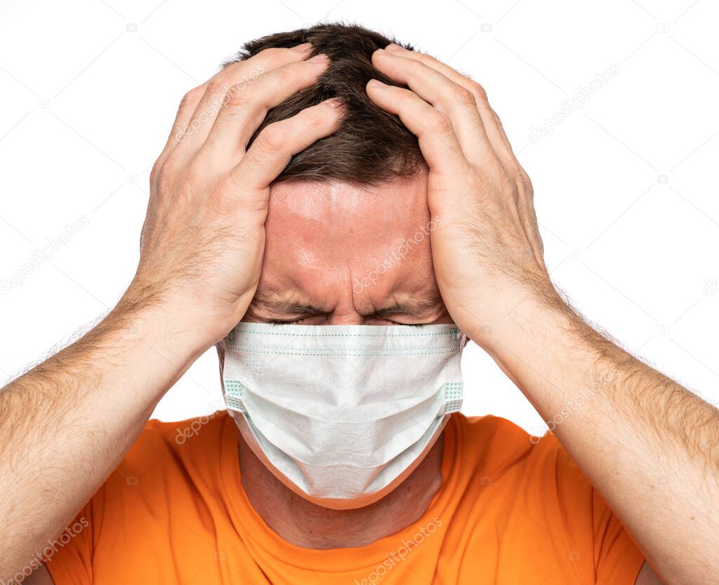 Healthcare, pain, stress and age concept. Sick man in mask. Man suffering from headach over white backgroun