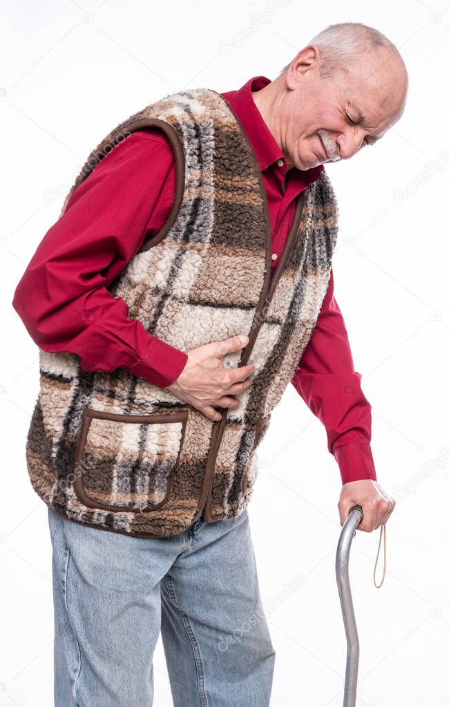 Healthcare concept. Unhappy senior man with a cane suffering from stomach ache over white background