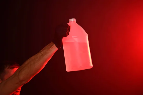 Man Fire Holding Bottle Water Red Smoky Background — Stock Photo, Image