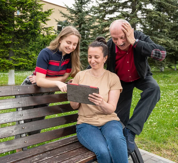公園の屋外でタブレットPcを使用して幸せな家族 — ストック写真
