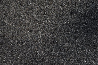 Asfaltın pürüzlü yüzeyi. Asfalt gri kumlu yol, doku arkaplanı