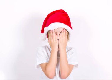Kırmızı şapkalı mutlu çocuk. Beyaz arka planda Noel konsepti. Metin için yeri olan pankart. İzole et