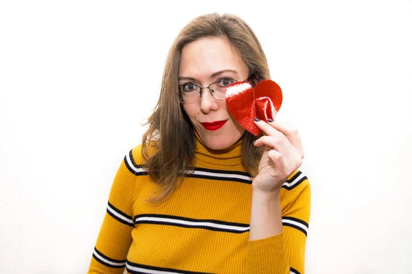 Smiling woman in glasses in yellow clothes with a heart red lipstick Valentine's Day on a white background