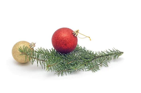 Een rode bal op kerstboom tak en meer gouden bal geïsoleerd op witte achtergrond. — Stockfoto