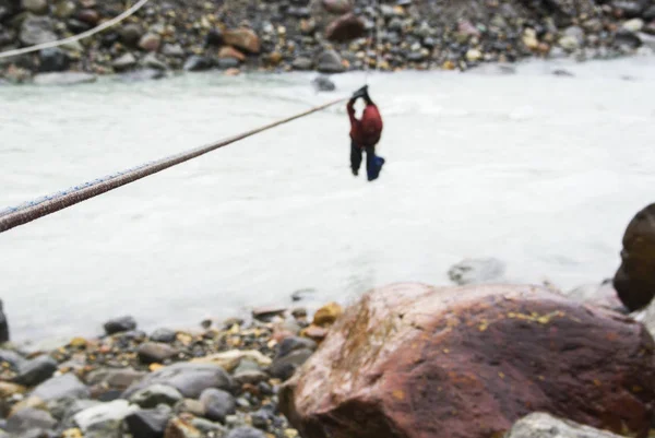 Tyrolean traverse crossing of a  river near  El Chalten in  Patagonia. Shallow depth of field, focus on the foreground rope.