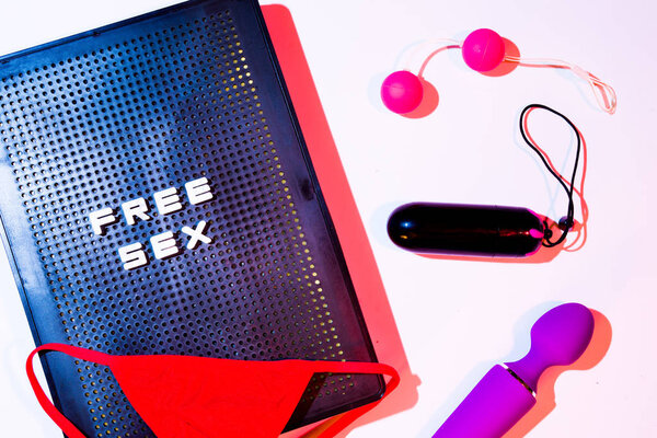 Red gstring  and sex toys on a pink background with a letterbox 
