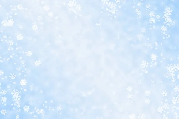 Falling snowflakes on a blue background — Stock Photo, Image