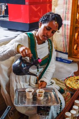 Ethiopian woman preparing coffee clipart