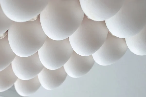 White eggs on white background. Minimalism pattern, concept design.
