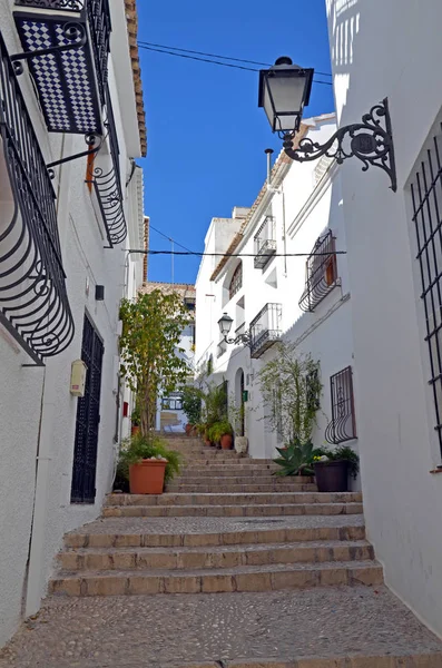 The old center of Altea in Spain. The town of Altea is built on a hill with winding streets and whitewashed houses.