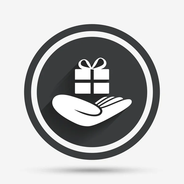 Give a gift sign. Hand holds present box. — Stock Vector