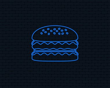Neon ışık. Hamburger simgesi. Burger yemek sembolü. Çizburger sandviç işareti. Grafik tasarım parlayan. Tuğla duvar. Vektör