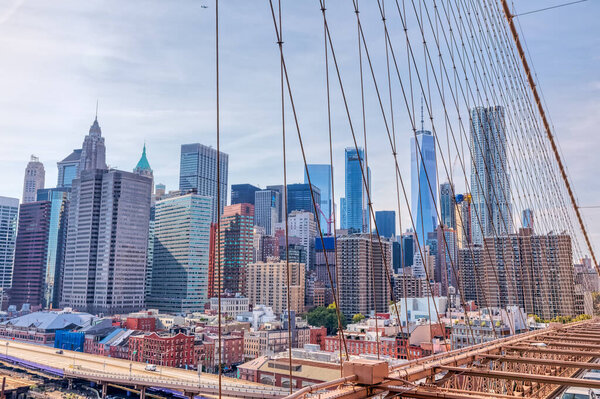 NEW YORK, USA - OCTOBER 1, 2018: View of Manhattan through the Brooklyn Bridge cables in New York.