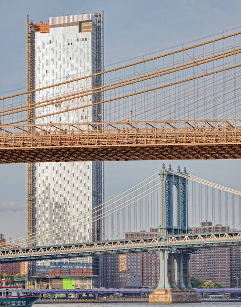 NEW YORK, USA - OCTOBER 1, 2018: One Manhattan Square building, Brooklyn Bridge and Manhattan Bridge in one frame. View from the Brooklyn Bridge Park.