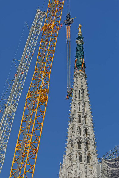 Zagreb, Croatia - April 17, 2020: Climbers hang on cable in operation to demolish earthquake damaged north tower of Zagreb Cathedral