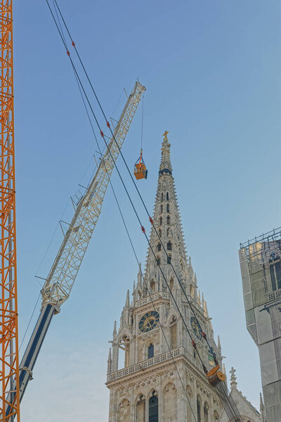 Zagreb, Croatia - April 16, 2020 : Cathedral belfries were damaged in an earthquake that hit Zagreb during Covid-19 quarantine. Engineers and alpinist prepare the north tower for controlled demolition
