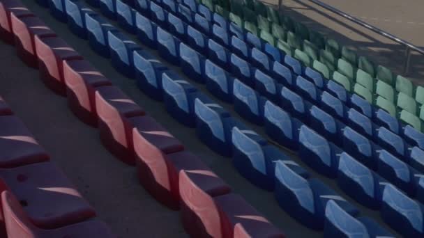 Blue, red and green chairs at the stadium — Stock Video