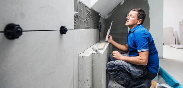 Middle Aged Tiler Installing Tiles Wall Home Indoors Renovation — ストック写真