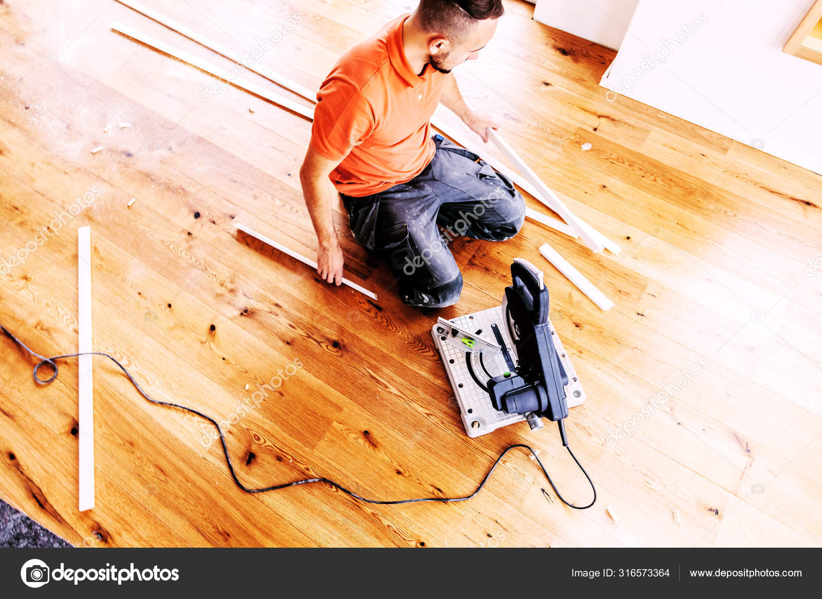 High Angle View Man Chop Saw Cutting Skirting Boards Construction