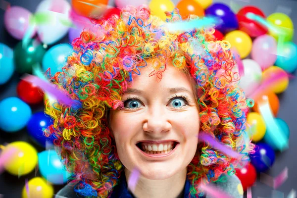 portrait of beautiful party woman in colorful wig having fun at carnival