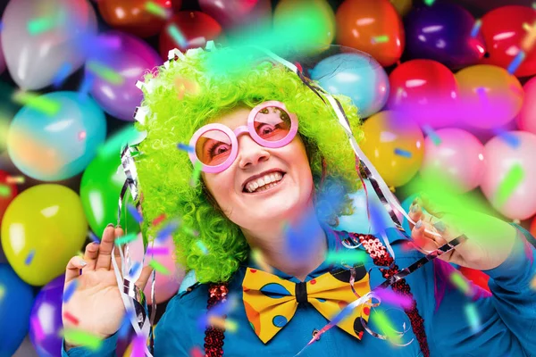 portrait of beautiful party woman in wig and glasses having fun at carnival