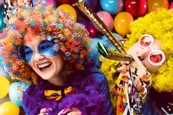 happy young couple celebrating at party for new years eve or carnival