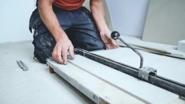 Adam duvara büyük formatlı fayanslar yerleştiriyor. konut yenileme konsepti