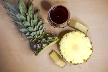 Pineapple with a glass of red wine