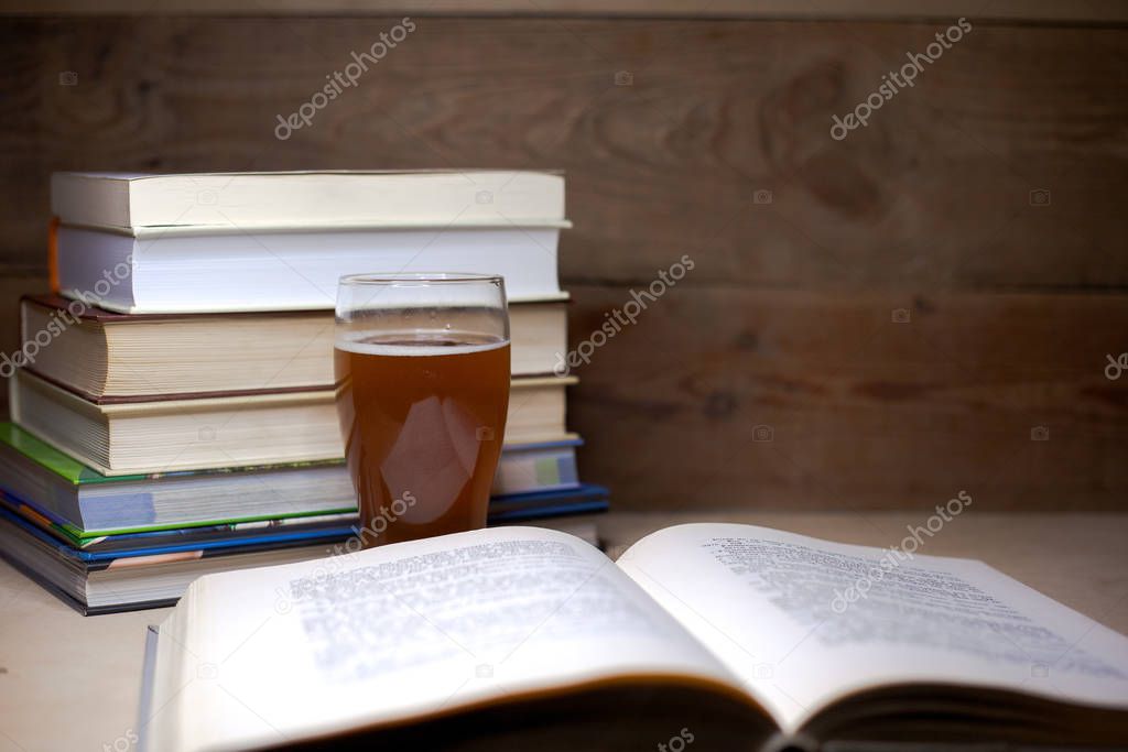 Old books with a glass of beer