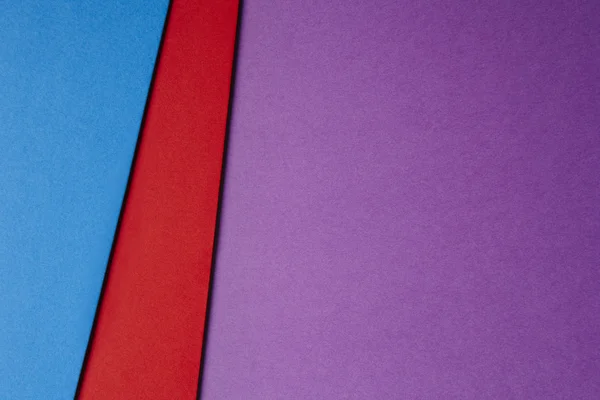 Colored cardboards background purple red blue tone. Copy space.