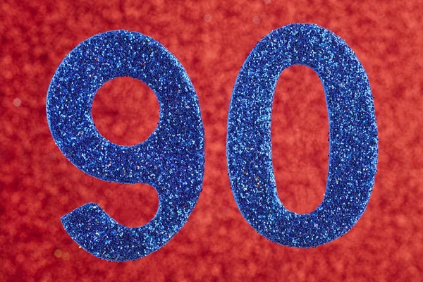 Αριθμός ενενήντα μπλε χρώμα πάνω σε κόκκινο φόντο. Επέτειος. — Φωτογραφία Αρχείου