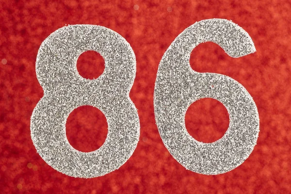 Number eighty-six silver color over a red background. Anniversar — Stock Photo, Image