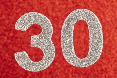 Otuz gümüş rengi kırmızı bir arka plan üzerinde numara. Yıldönümü. H
