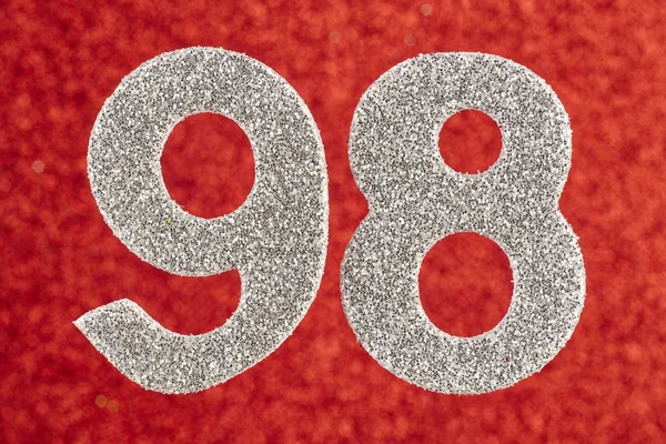 Number ninety-eight silver color over a red background. Annivers — Stock Photo, Image