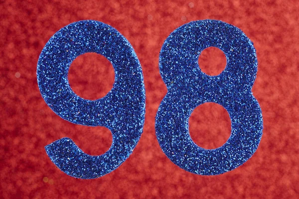 Numer dziewięćdziesiąt osiem niebieski kolor na czerwonym tle. Anniversar — Zdjęcie stockowe