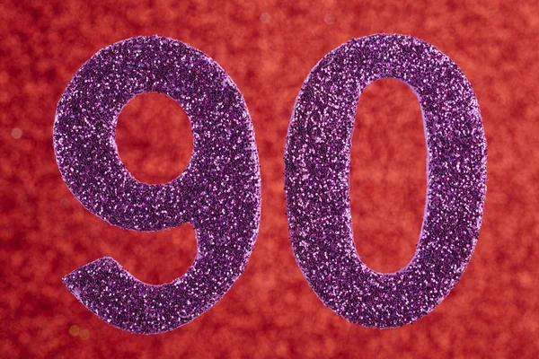 Number ninety purple color over a red background. Anniversary. — Stock Photo, Image