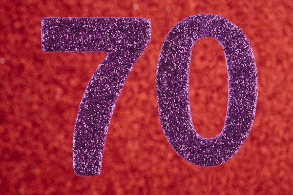 Номер семьдесят фиолетовый цвет на красном фоне. Юбилей . — стоковое фото