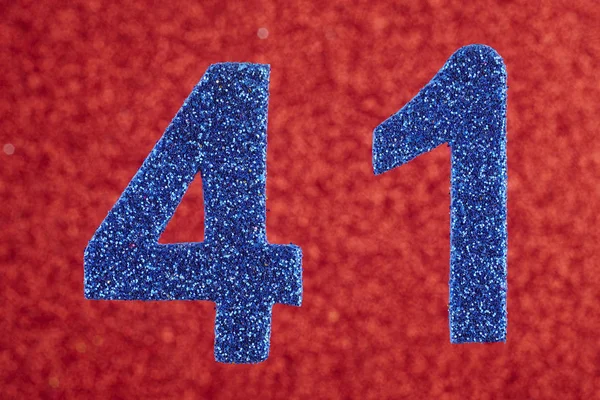 Número cuarenta y un color azul sobre un fondo rojo. Aniversario . — Foto de Stock