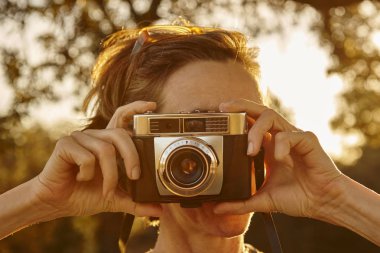 Kadın vintage fotoğraf makinesi ile fotoğraf çekmek. Seyahat 